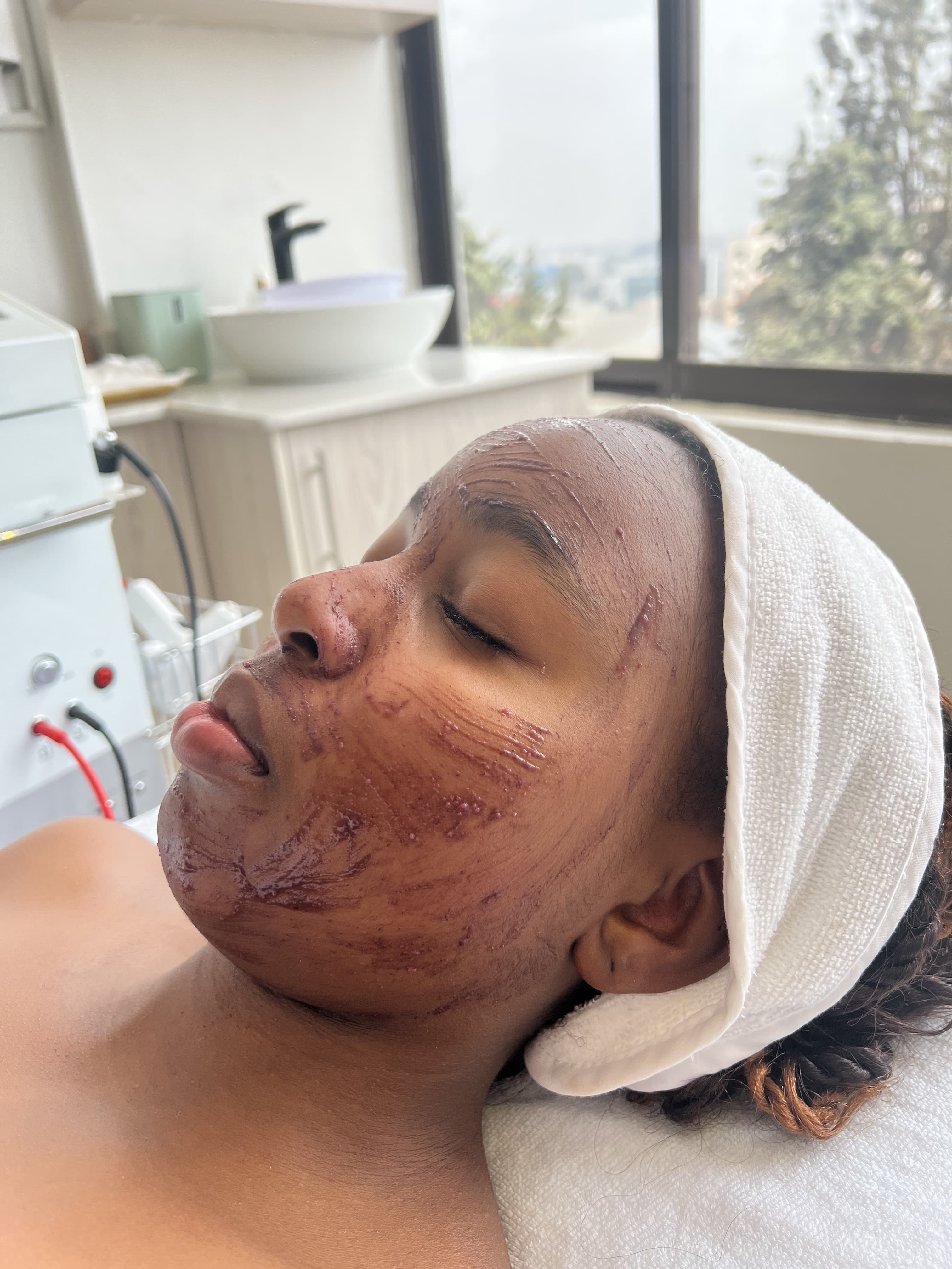 Inside the Skin by Lyze studio in Nairobi during a corneotherapy facial, with treatment equipment and a bright city view
